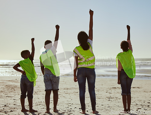 Image of Back, activist and volunteer with friends on the beach for the conservation of the environment or sustainability. Charity, motivation and teamwork with a friend group cleaning or recycling for earth