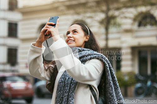 Image of Travel, tourist and photograph with a woman in the city taking a picture while traveling abroad on holiday or vacation. Phone, tourism and mobile with a female traveler while sightseeing overseas