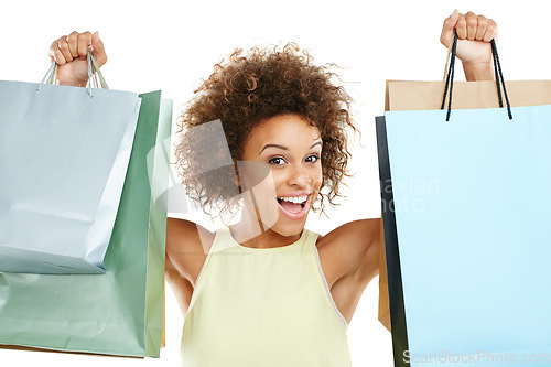 Image of Portrait, shopping and retail with a black woman in studio isolated on a white background while holding shopping bags. Store, customer and discount with a female model on black space for marketing