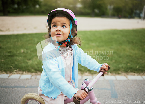 Image of Cycling, fun and child on a bike in the park, outdoor activity and learning in New Zealand. port, happiness and girl kid playing on a bicycle ride in the neighborhood street or road in childhood