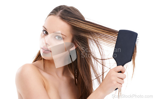 Image of Beautiful, young and woman brushing hair for self love and self care or hygiene against a white studio background. Portrait of isolated attractive female using brush for haircare or hair treatment