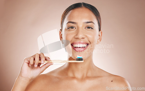 Image of Woman, portrait or brushing teeth in grooming, dental hygiene or healthcare wellness on pink studio background. Smile, happy or beauty model and toothbrush, toothpaste cleaning or eco friendly bamboo