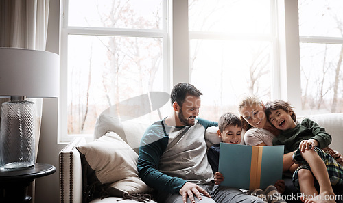 Image of Books, reading and couple with children on couch for storytelling time in living room of happy home. Love, learning and growth, woman and man with kids, book and fantasy story smile on sofa together.