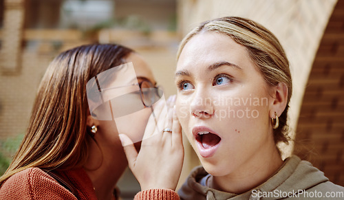 Image of Women gossip, surprise and friends with secret in university campus. Face wow, hands and female students whisper shocking info, gossiping or sharing rumor, secrets or story and chatting in college.