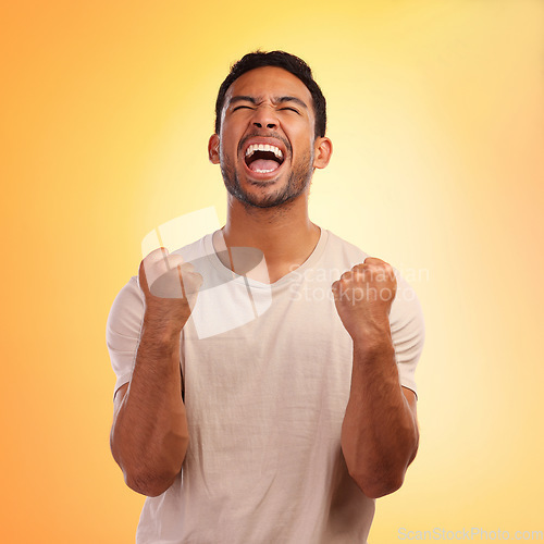 Image of Winner, screaming man and celebration in studio isolated on a yellow background. Winning, wow and happy young male fist pump for celebrating goals, targets achievement or victory, success or lottery.