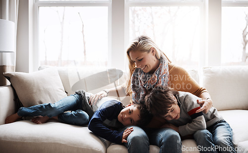 Image of Happy family, mother bonding with children and relax on sofa for love, care and smile at home together. People, mom and kids lying on couch in the living room for cozy winter hug or fun with parent