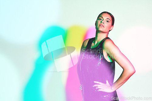 Image of Woman, fashion portrait and neon shadow for a kaleidoscope party with color on a studio background. Beauty, art and aesthetic model confident about creative style for magazine mockup or copyspace