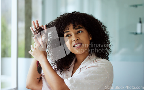 Image of Beauty, hair and afro girl bathroom routine for curly texture style and grooming in mirror. Hair care, self care and black woman thinking of cosmetic treatment in home with thoughtful face.