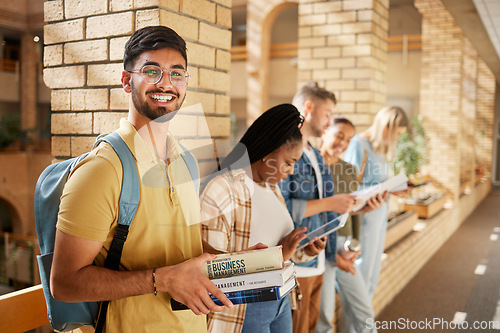 Image of University, hallway and portrait of Indian man and students standing in row together with books at business school. Friends, education and future, happy man in study group on campus in lobby for exam