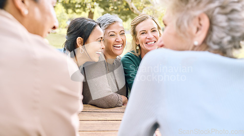 Image of Senior, happy or friends in a park talking or speaking of funny gossip while relaxing holiday vacation in summer. Smile, old people or elderly women laughing at a crazy joke or bonding in nature