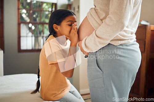 Image of Pregnant, family and secret with a girl whispering to the belly of her mother while bonding in the bedroom of their home. Kids, mom and pregnancy with a daughter talking to the stomach of her mama