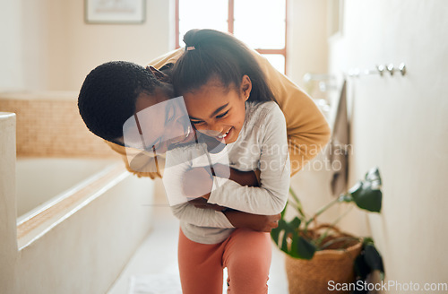 Image of Black family, father and child for a hug in happy home with love, care and support in bathroom. Man and girl kid together for happiness with smile, energy and embrace for safety, health and wellness