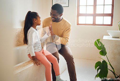 Image of Black family, high five and happy child with father in home bathroom with love, care and support. Man and girl kid for a pep talk and communication with a smile, energy and celebration of trust