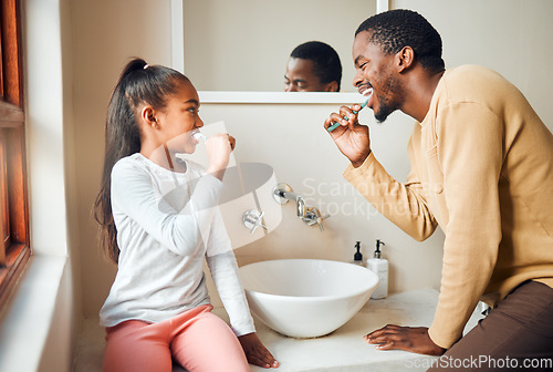 Image of Brushing teeth, dental health and father with daughter in a bathroom for hygiene, grooming and bonding. Oral care, girl and parent, people and cleaning while having fun, playful and smile at home