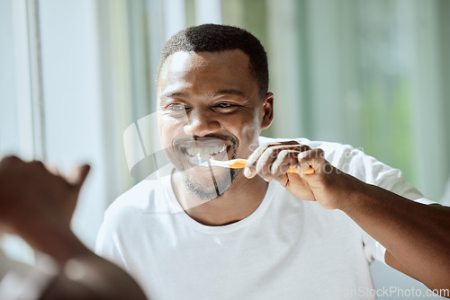 Image of Morning, black man and dental brush wellness for health, hygiene and clean smile in mirror. Self care, cleaning and oral hygiene for healthy teeth of person smiling with confidence in home.
