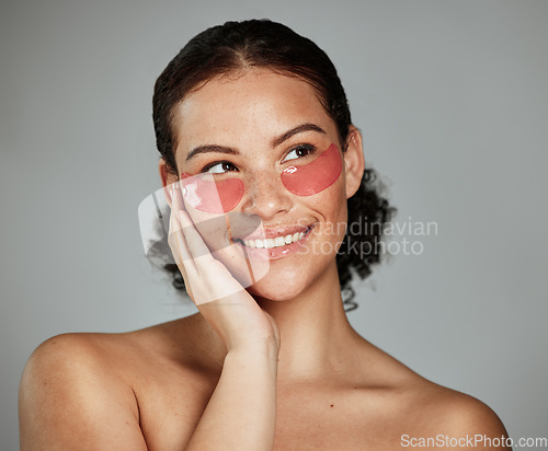 Image of Black woman, face skincare and eyes patches for beauty wellness, cosmetics dermatology and luxury anti aging treatment. African model, smile and glowing skin or spa facial mask product in studio