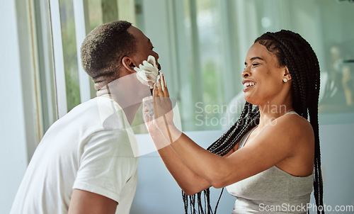 Image of Skincare, happy couple in bathroom and shaving face with at home facial product for male facial treatment. Laughing together in home, natural beauty and girlfriend helping black man with application