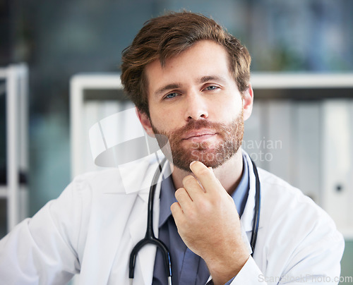 Image of Portrait, thinking and healthcare with a doctor man sitting in his office of a hospital for consulting or treatment. Face, idea and medical with a male medicine professional in a clinic for care