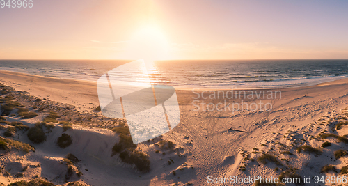 Image of Aerial view of beach at sunset