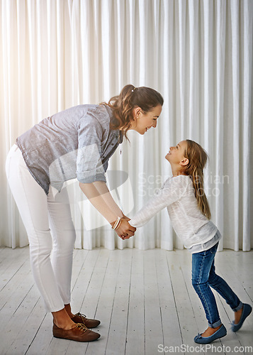 Image of Happy, family and mom with girl at home holding hands to show love, care and happiness. Lens flare, mother and kid together having fun in a house laughing, playing and holding hand with parent