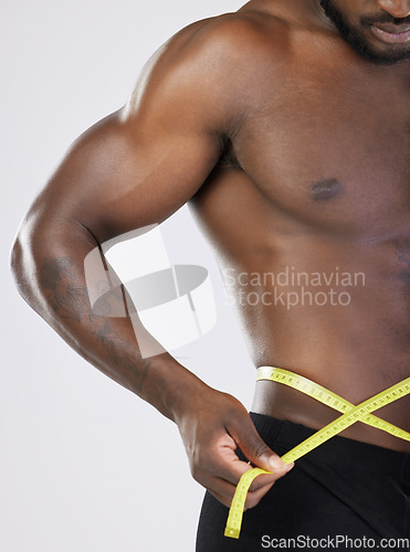 Image of Tape, fitness and diet man isolated on white background for lose weight, bodybuilder and training and wellness. Bodybuilding, athlete or sports black person measuring his waist, stomach or muscle