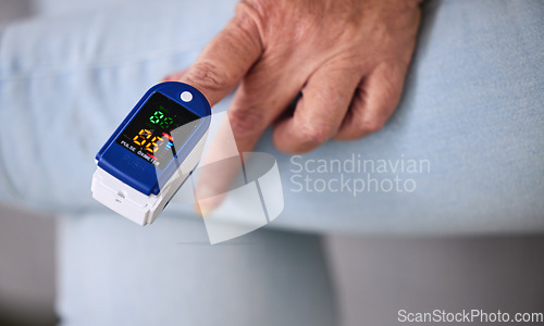 Image of Medical, heart rate and woman with a pulse oximeter in a retirement home during consultation. Healthcare, treatment and senior female patient measuring her oxygen blood levels with health device.