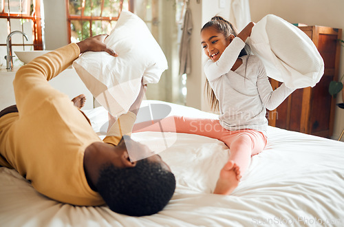 Image of Happy pillow fight, father and child on bed playing, bonding and crazy fun for dad and daughter time in home. Family, love and playful energy, black man with girl hitting and laughing in bedroom.