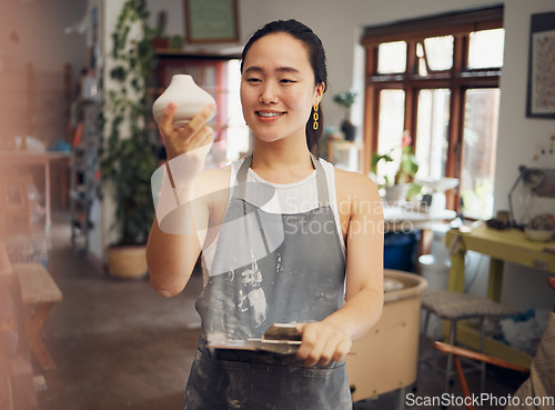 Image of Creative, art and woman in workshop with clay pot, ceramics and pottery with creativity and pride in work. Happy artist with texture, sculpting and creation in hand with clipboard for product check