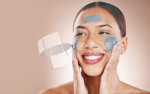 Image of Skincare, beauty and woman with a face mask in a studio for a cosmetic, wellness and natural routine. Cosmetics, mockup space and female model from Brazil with facial treatment by a brown background.