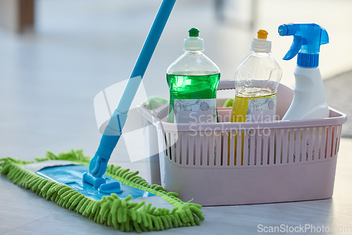 Image of Cleaning, product and basket with mop, bottle and spray for cleaning services, wellness or chemical disinfection. Closeup of spring cleaning supplies, container and tools to dust house, floor or home