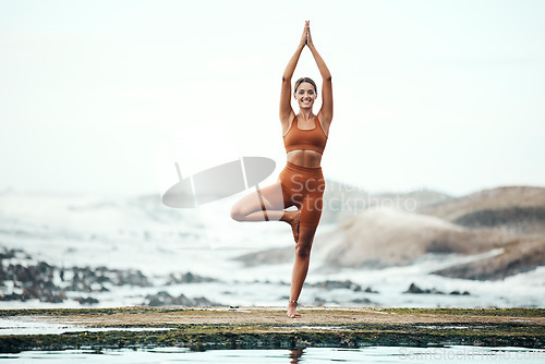 Image of Yoga, woman and stretching on beach, workout or fitness for balance, wellness or health. Female, girl or exercise for training on seaside, zen or practice for performance, healthy or energy for power