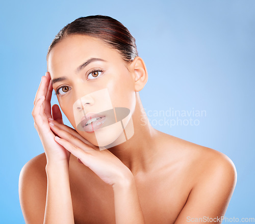 Image of Portrait, woman and skincare on studio blue background for beauty salon, body makeup and cosmetics. Young model, face headshot and natural glow of luxury facial, aesthetic wellness and healthy shine