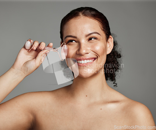 Image of Woman, beauty and skincare with derma roller for anti aging face with smile for cosmetics against grey studio background. Happy female smiling with roller in satisfaction for lifting treatment