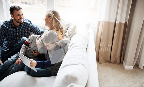 Image of Family, sofa and boy siblings with tablet, mom and dad in happy conversation in home living room. Happy family together, couch and kids with mobile touchscreen tech for learning, gaming or bonding