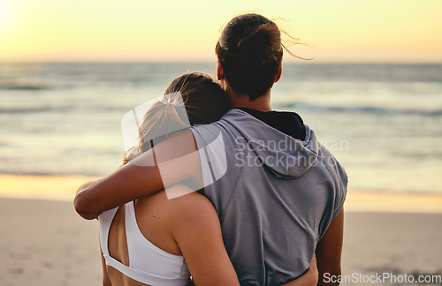 Image of Hug, fitness and back of couple at the beach for sunset training, exercise and workout with a view. Peace, gratitude and runner man and woman hugging with affection after cardio at the ocean