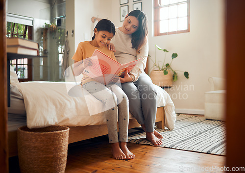 Image of Storytelling, book and mother bonding with child for home learning, language development and hobby in bedroom. Family, Indian people or mom and kid reading for education, creativity and teaching