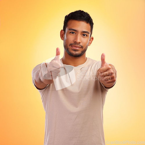 Image of Portrait, hands and man with thumbs up in studio isolated on a yellow background. Face, fashion and stylish, trendy or cool male with thumbsup for support, thank you or like, emoji or ok hand gesture