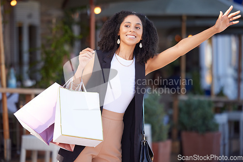 Image of Black woman, shopping and city street as happy customer waves hand for cab or taxi on urban street with retail bags. Travel, fashion and smile of female while waiting for transport outdoor in France