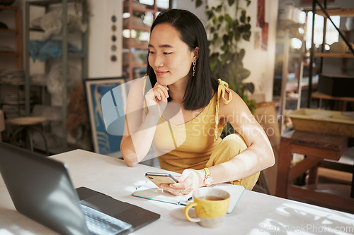 Image of Asian woman, laptop and phone thinking in small business marketing, advertising or retail planning at the workshop. Creative woman contemplating business startup or market strategy plan on computer