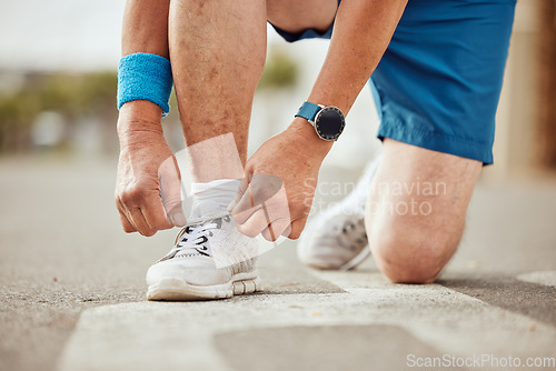 Image of Runner, fitness or hands tie shoes to start training, cardio workout or sports exercise in city road. Legs, man or healthy sports athlete with running shoes or footwear laces ready for body goals