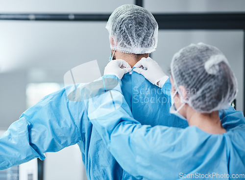 Image of Doctor, uniform and theatre clothes for surgery, operation and medical healthcare. Nurse helping surgeon with safety scrubs, hospital ppe and emergency operating room in clinic for medicine teamwork