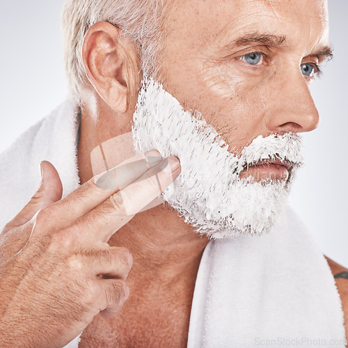Image of Man face, hands or grooming shaving foam in health maintenance or beauty aesthetic on gray studio background. Zoom, mature model or hair removal cream in facial cleaning, growth or hygiene skincare