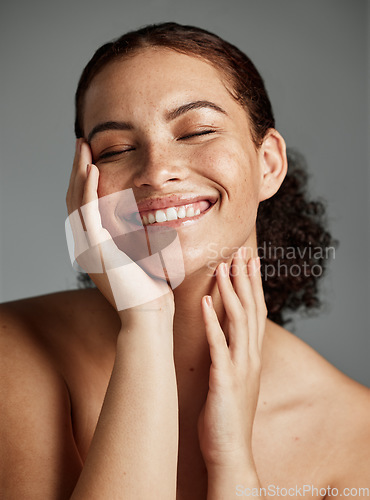 Image of Face, beauty and skincare with a model black woman in studio on a gray background to promote natural care. Facial, wellness and makeup with an attractive young female happy with her skin product