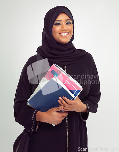Image of Portrait, muslim and books with a student woman in studio on a gray background for learning or education. Islam, university and study with an islamic female at college to study on a scholarship