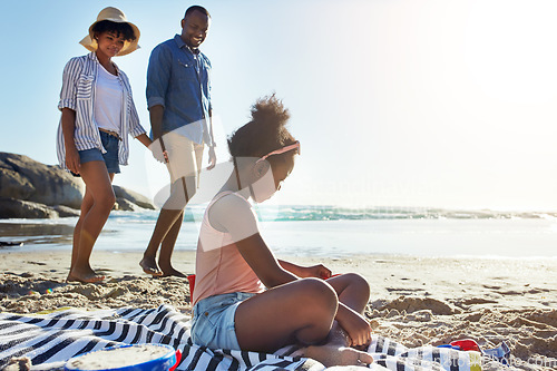 Image of Fun, relax and girl at the beach with parents for holiday, summer and travel in Portugal. Freedom, playful and black family at the ocean for a vacation, fresh air and coastal trip at the sea