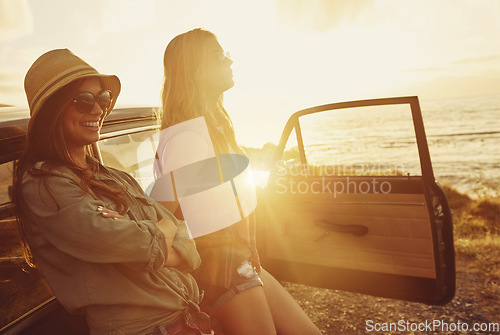 Image of Friends at sunset, women and car beach with travel and adventure on road trip, outdoor with nature and sea holiday. Happy people, freedom and gen z youth on summer vacation, happiness with lens flare