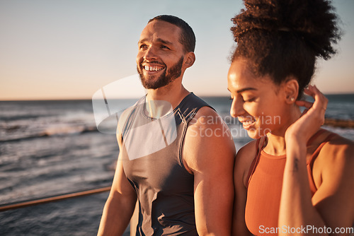 Image of Black couple, fitness and walking at the beach in conversation or talk together with smile for the outdoors. Happy man and woman enjoying fun sunset walk smiling for holiday break by the ocean coast