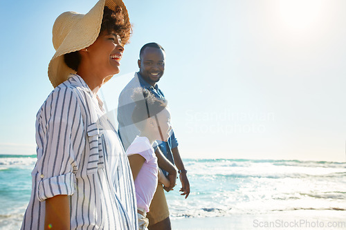 Image of Family, travel and walking on a beach with a child or kid on vacation at the ocean or sea. Mock up, parents and happy African American daughter relaxing and enjoying trip or holiday and holding hands