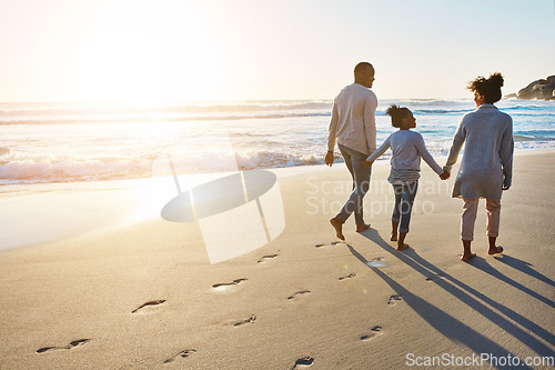 Image of Black family, sunset and beach walk during summer on vacation relaxing at a peaceful scenery by the ocean. Sea, footprints and parents with daughter, child or kid with childhood freedom