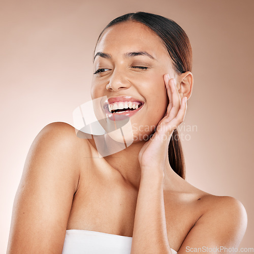 Image of Skincare, beauty and happiness, woman with smile laughing on studio background at fun spa. Makeup, glamour and wink, luxury skin care with hands on face, natural detox facial massage on happy woman.